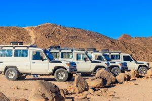 Off road SUV cars in bedouin village in Arabian desert near Hurghada, Egypt